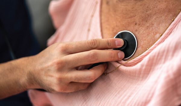 A close up of someone using a stethoscope on someone else