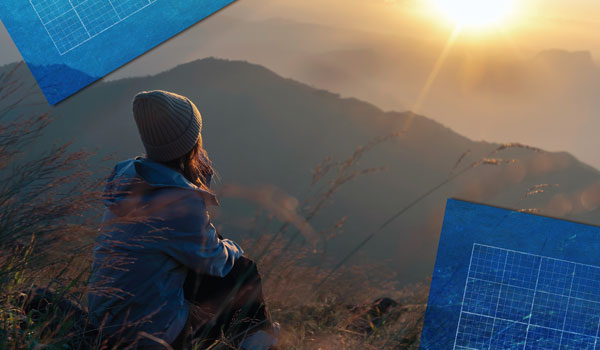 A woman sitting outside looking out at the sunrise/sunset, blueprints at corners of image